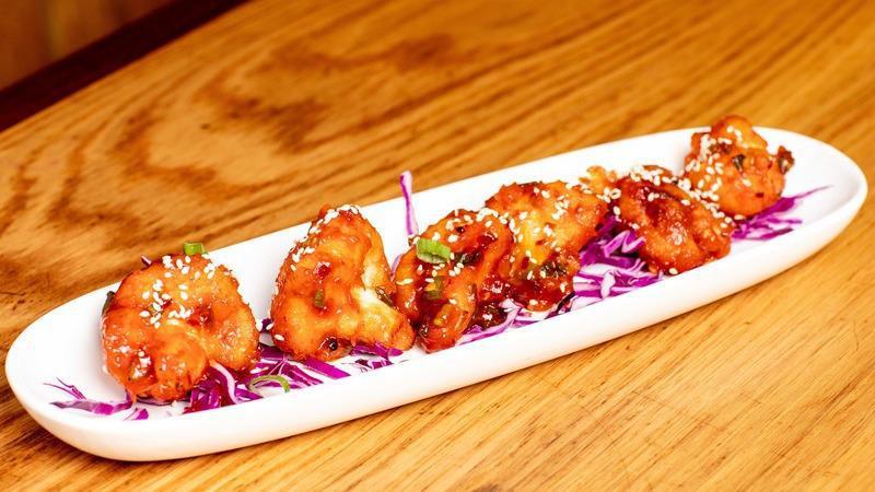 Jomsom Cauliflower · Vegetarian. Gluten free. Crispy cauliflower florets tossed in a spicy soy and tangy sauce.