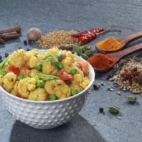 Aloo Veg (with Rice) · Satisfying chickpeas with potato, mixed green vegetables cooked in a curry sauce with homema...