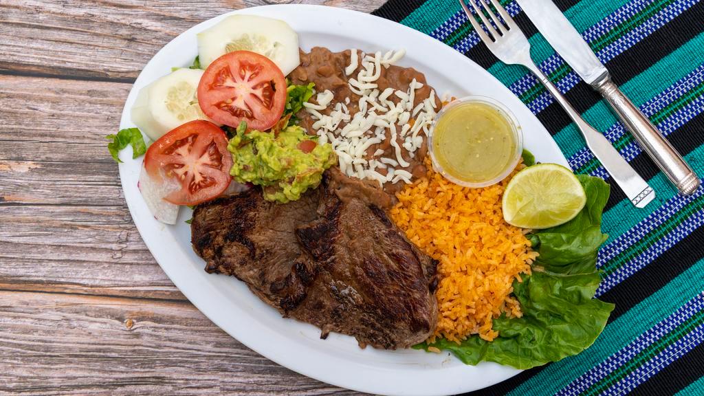 Churrasco Chapin · Thin steak served with black beans, rice, salad, grilled onions and fresh tortillas.