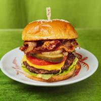 Bacon Burger · Bacon cheeseburger with lettuce, tomato, pickles, caramelized onions and house sauce.