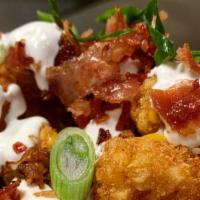 Fully Loaded Tots · A pile of crispy tater tots, loaded with cheddar and jack cheese, bacon, sour cream, and thi...