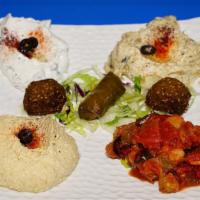 11. Appetizer Combo · Hummus, Baba Ganoush, Dolma, Cacik, Falafel, and Sautéed Eggplant.