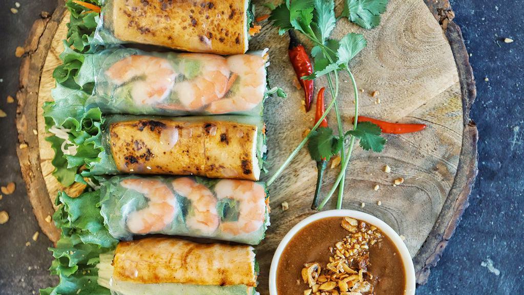Spring Rolls · 4 PC Shrimp and pork belly with vermicelli noodles wrapped with fresh herbs in rice paper. 
Served with peanut sauce.