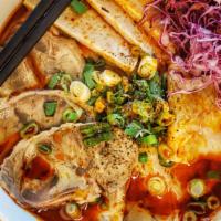 Bun Bo Hue · Housemade spicy beef broth with thick cut noodles, pork shank, peppered Vietnamese ham, and ...