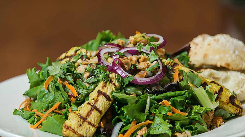 Bangkok Salad · Mixed greens served with ginger curry marinated grilled chicken, red onion, mint, cilantro, roasted peanuts, and spicy lemongrass vinaigrette.
