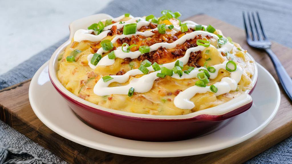 Loaded Baked Potato Mac · The Ultimate Mash Up! 🥔 Mashed potatoes, bacon, sharp cheddar cheese and scallions, topped with sour cream.