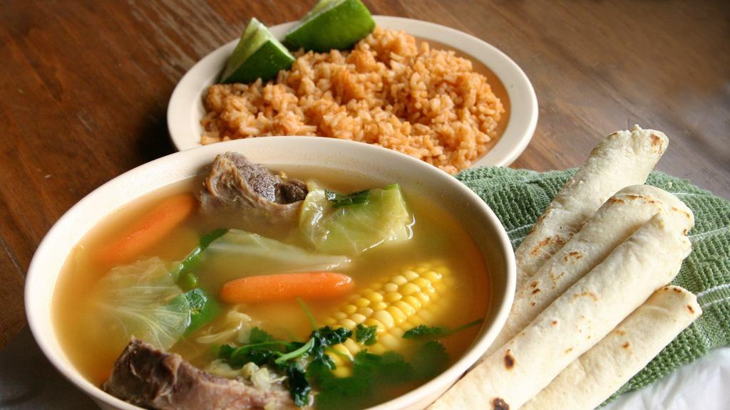 Beef Soup · Beef shank cooked with oxtail, fresh corn, zucchini, yuca, carrots, onions, white cabbage served with a side of rice.