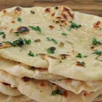 Garlic Naan · Bread stuffed with garlic and backell in a clay oven.