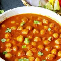 V2. Channa Masala · Chick peas delicately cooked with selected exotic spices.