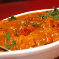 C6. Butter Chicken · Boneless tandoori chicken barbecued in a clay oven, cooked in a very special curry sauce wit...