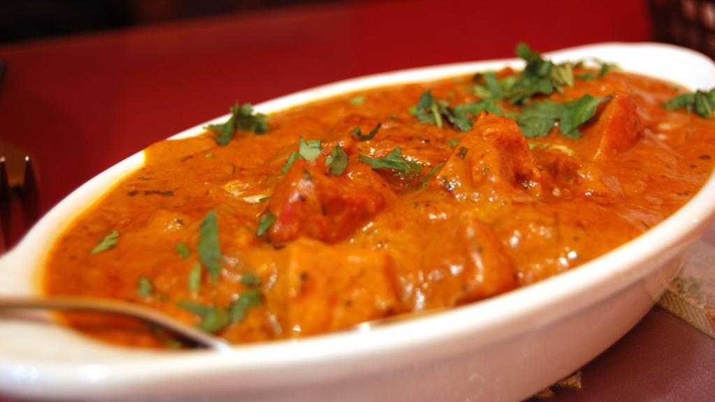 C6. Butter Chicken · Boneless tandoori chicken barbecued in a clay oven, cooked in a very special curry sauce with selected herbs and spices.