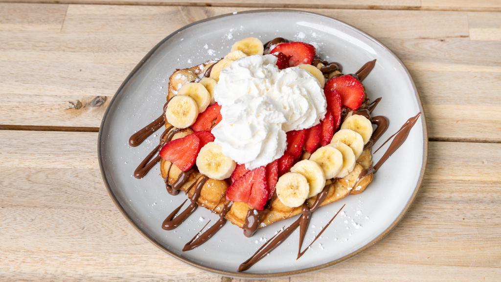 The Nutella Works Waffle · One single bubble waffle topped with Nutella, bananas, strawberries and topped with powdered sugar and whipped cream