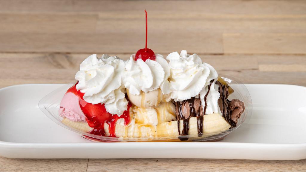 Original Banana Split · sliced banana topped with a scoop each of vanilla, chocolate and strawberry ice cream, caramel/vanilla/chocolate syrup, whipped cream and a cherry.