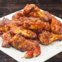 Buffalo Wings · Baked, all natural chicken tossed in Frank's red-hot sauce. Served with side of ranch dressi...