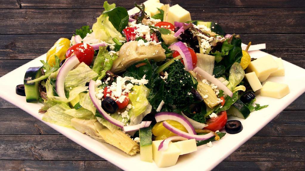 Greek Dinner Salad · Lettuce, tomatoes, onion, olives, cucumber, artichoke hearts, carrots, pepperoncini, and feta cheese.