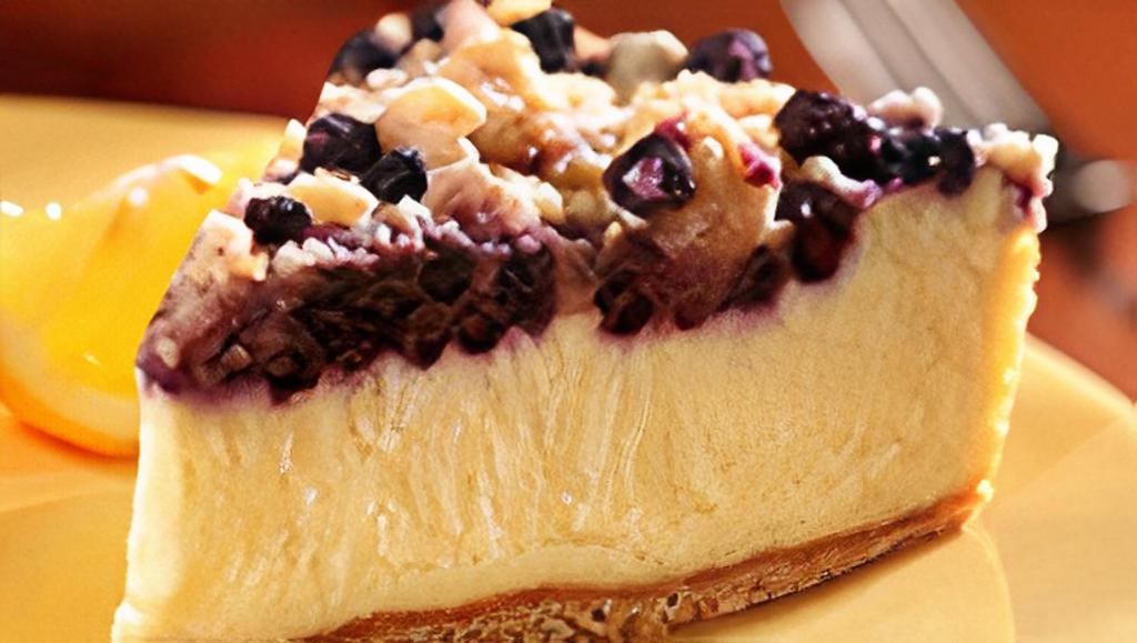 Lemon Blueberry Cheesecake · Creamy lemon cheesecake topped with blueberries and brown sugar crumbs