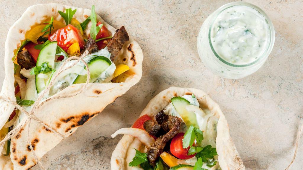 Halal Lamb & Beef Gyro Wrap · Lavash bread, lettuce, tomatoes, cucumbers, house dressing, taziki and lamb and beef gyro.