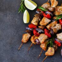 Chicken Shish Kebob Plate · Chicken shish kebobs served with rice and salad.