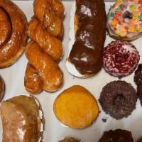1 Dozen Assorted Fancy Donuts  · Apple Fritter, Maple Custard Bar, Chocolate Custard Bar, Cinnamon Twist, Sprinkles Raised, F...