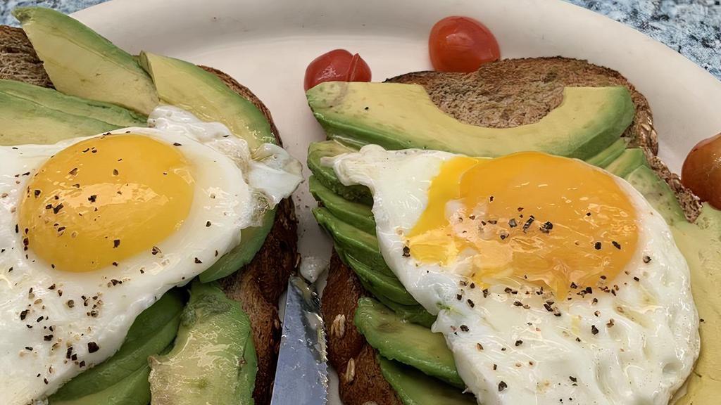avocado toast · served on toasted whole wheat  with two  eggs cooked to order with sprinkling of salt and pepper  and cherry  tomato , with a side of cup of fruit