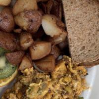 Wake-Up! Scramble · Three eggs scrambled with spicy housemade chorizo, red, onions, avocado, corn, and queso fre...