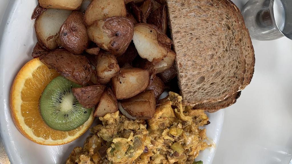 Wake-Up! Scramble · Three eggs scrambled with spicy housemade chorizo, red, onions, avocado, corn, and queso fresco.