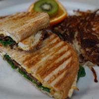 Breakfast Panini · Over hard eggs on grilled sourdough with your choice of bacon or thin sliced ham, spinach, a...