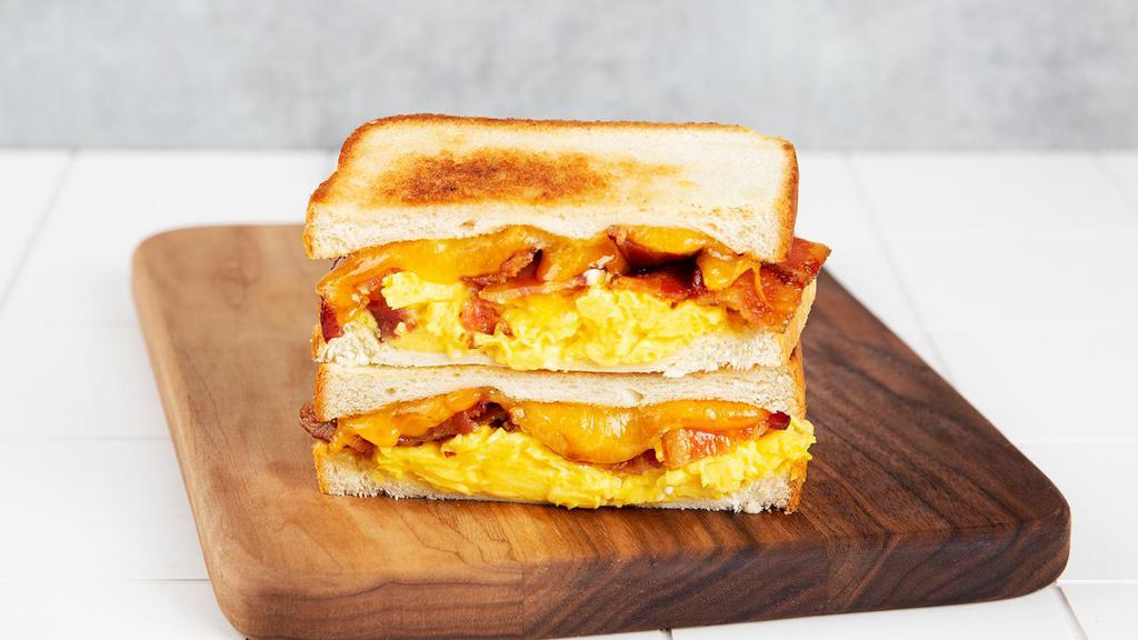 Breakfast Melt · Griddled sandwich with fried egg, melted yellow cheddar cheese, bacon, and your choice of bread.