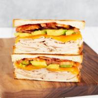 Turkey Club · Griddled sandwich with turkey, bacon, melty yellow cheddar, tomato, avocado, mayonnaise, and...