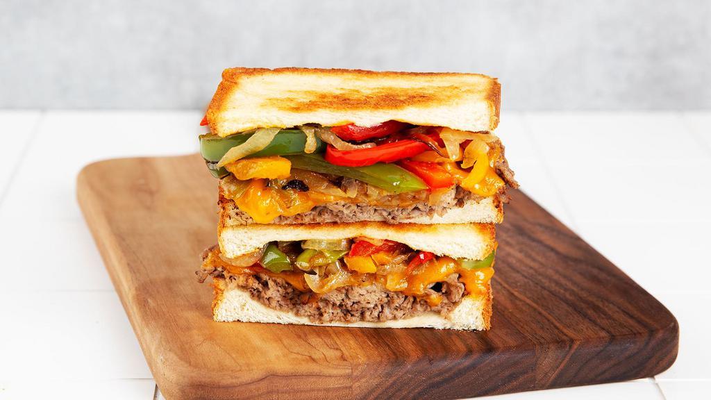 Philly Steak Melt · Griddled sandwich with chopped steak, melted yellow cheddar cheese, caramelized onions, sauteed bell peppers, and your choice of bread.