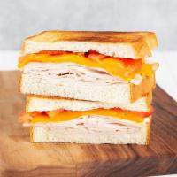 Turkey Melt · Griddled sandwich with turkey, melty yellow cheddar, tomato, and your choice of bread.