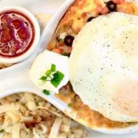 Huevos Rancheros · A flour tortilla layered with black beans, Jack and Cheddar cheese and two eggs any style. T...
