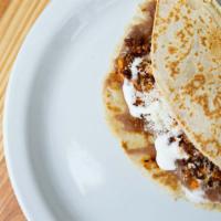 Baleada · Handmade flour tortilla with eggs and chorizo, beans, sour cream and cheese.