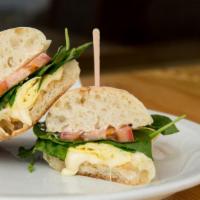 Egg Panini · Breakfast sandwich of eggs, swiss cheese, spinach, tomato and our house spread