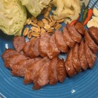 E-saan Sausage · Northeastern Thailand sour pork sausage, served w/ pickled ginger, peanut, cabbage.