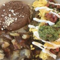 Chilaquiles · Tortilla chips, red or green sauce with eggs and refried beans, guacamole, pico de gallo, so...