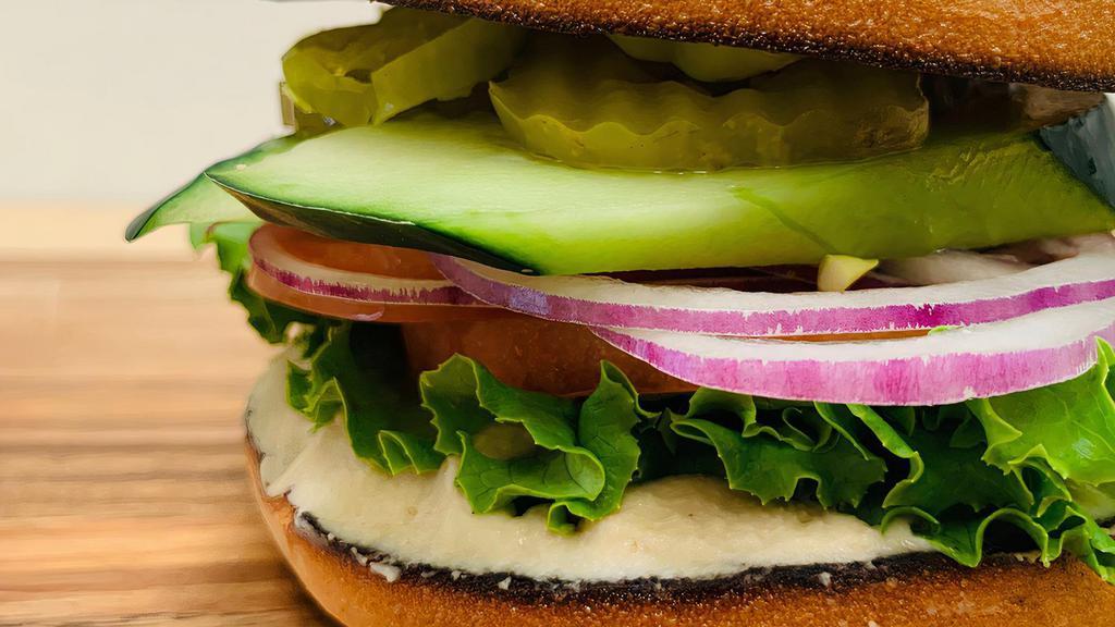 Hummus Sandwich · Bagel with hummus, mayo, mustard, lettuce, tomato, onion, cucumbers, pickles, and pepperoncini.
