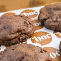 Triple Choc Cookie Box · A box of four soft, giant chocolate cookies filled with a medley of melty pools of dark choc...