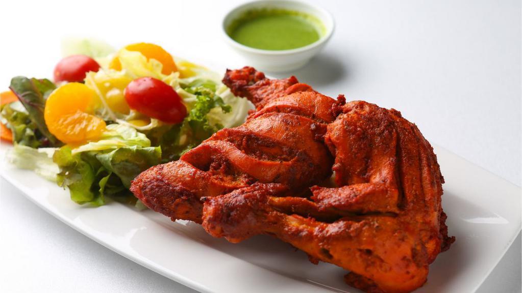 Tandoori Chicken · Chicken legs marinated with spices & yogurt sauce & cooked in clay oven.