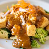 Praram Tofu · Gluten-free. Crispy tofu served on a bed of steamed vegetable, topped with Thai peanut sauce...
