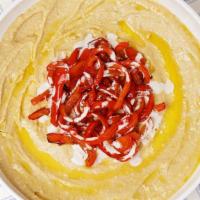 Original Hummus Bowl · Original hummus drizzled in olive oil and spices served with tahini and a side of pita bread.