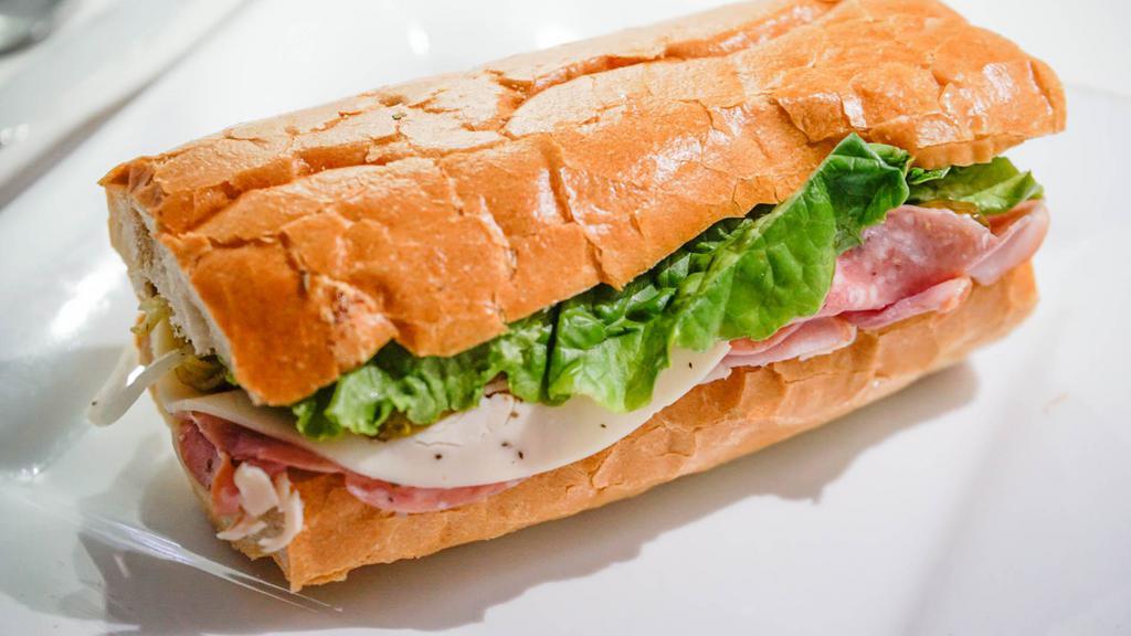 ROASTED BEEF B · Roasted Beef , greens lettuce, fresh cut tomatoes, homemade horseradish mayonnaise, and melted Swiss cheese on a French Baguette . Served with your choice of side.