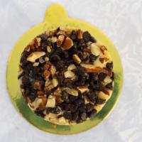 Turtle Cheesecake · Creamy cheesecake topped with chocolate chips, caramel, and pecans atop a chocolate cookie c...