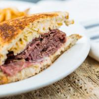 Max’s Famous Reuben · Choice of corned beef or pastrami, sauerkraut, Swiss cheese and 1000 island dressing on gril...