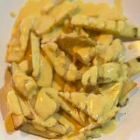 Huancaina Fries · Peruvian Yellow pepper paste over French Fries.
