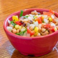 Lola Friola · A marinated blend of black-eyed peas, fresh corn, onions, yellow and red bell peppers, tomat...