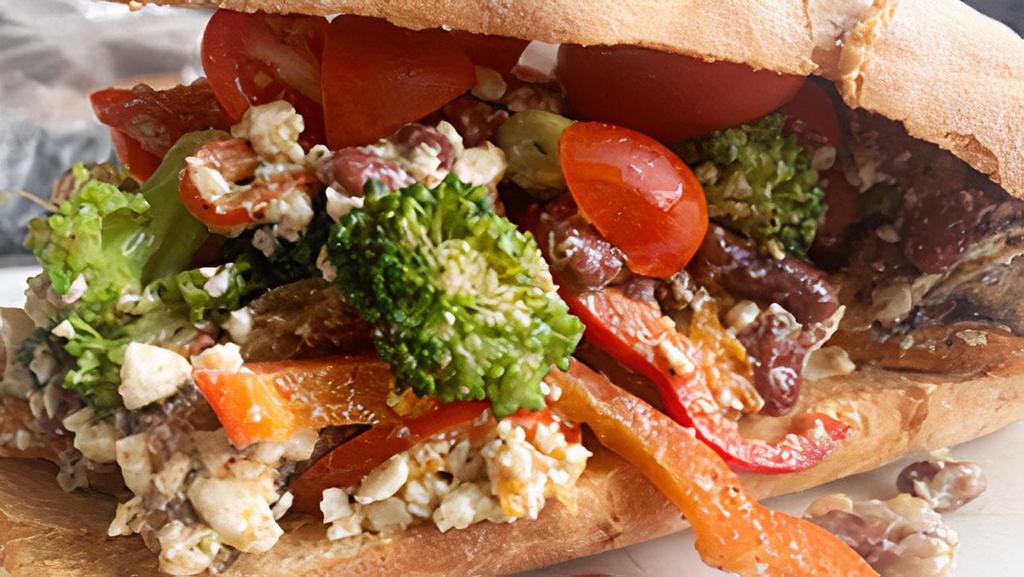 Veggie Pita Wrap · Wrapped in toasted pita bread with hummus.  Roasted broccoli, green beans, bell peppers, kidney beans, toasted almonds, cherry tomatoes, cucumbers, feta cheese tossed with almond pesto.