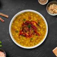 Daal Masala · Traditional Indian yellow lentil soup tempered with fried onion, tomato and special spices.