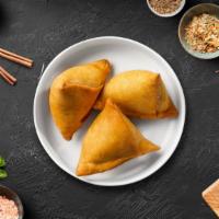 Vegetable Samosa · 2 crispy puffs stuffed with potatoes and peas. Served with homemade mint and tamarind chutney.