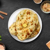 Cheese Naan · Freshly baked bread in a clay oven garnished with cheese and butter